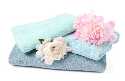 Photo of Soft towels and peony flowers isolated on white