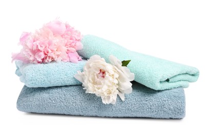 Photo of Soft towels and peony flowers isolated on white