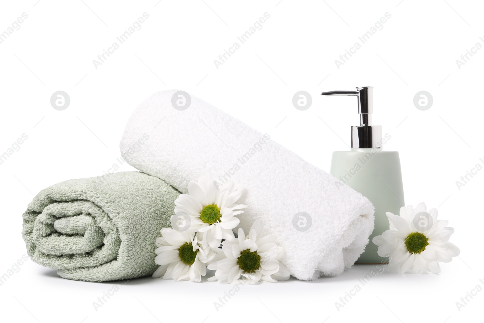 Soft towels, chrysanthemum flowers and liquid soap isolated on white Photo of Soft towels, chrysanthemum flowers and liquid soap isolated on white