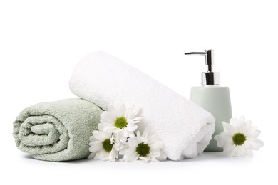 Photo of Soft towels, chrysanthemum flowers and liquid soap isolated on white
