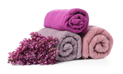 Photo of Soft towels and lilac flowers isolated on white