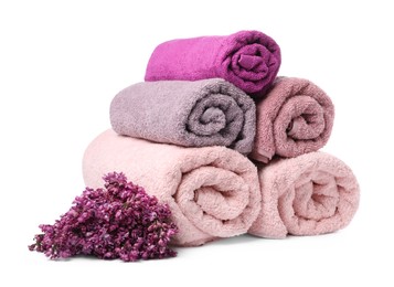 Photo of Soft towels and lilac flowers isolated on white