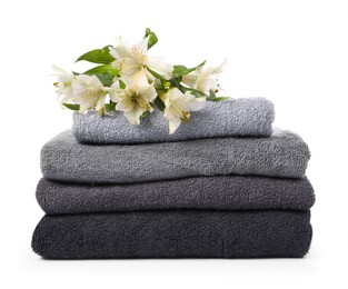 Photo of Stack of soft towels and lilies isolated on white