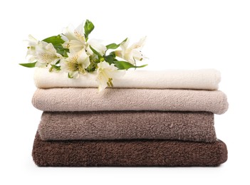 Photo of Stack of soft towels and lilies isolated on white