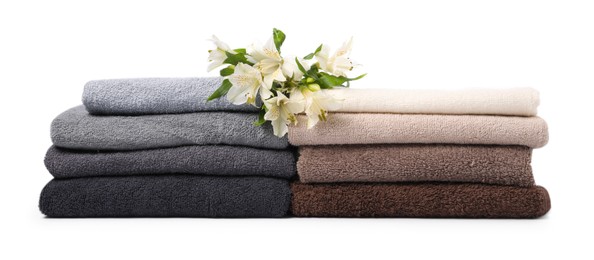 Photo of Stack of soft towels and lilies isolated on white