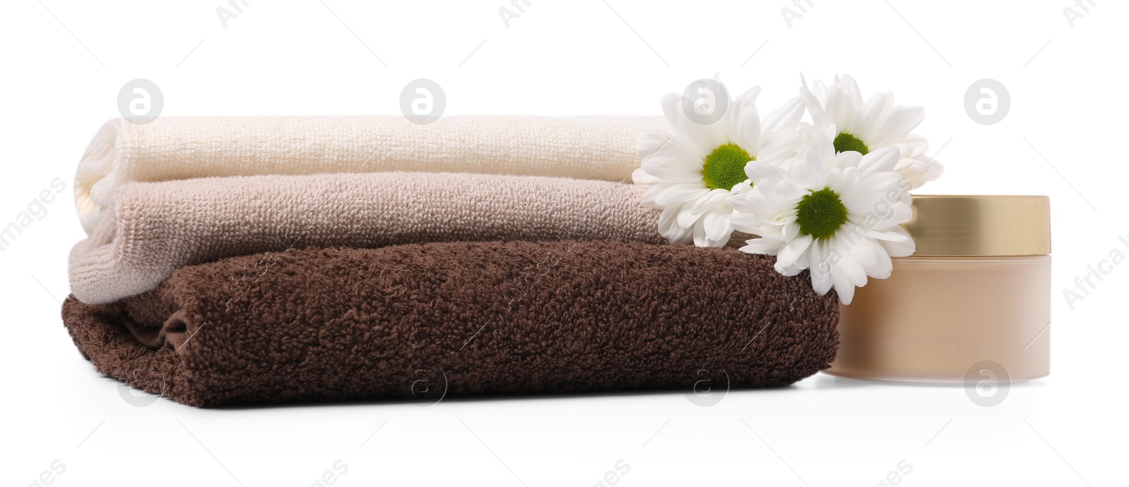 Stack of soft towels, cosmetic product and chrysanthemum flowers isolated on white Photo of Stack of soft towels, cosmetic product and chrysanthemum flowers isolated on white