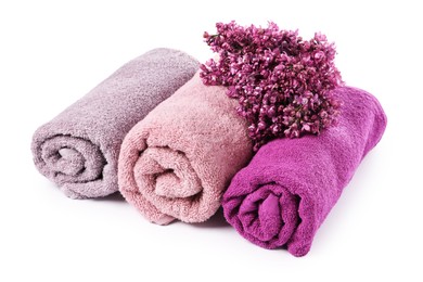 Photo of Soft towels and lilac flowers isolated on white