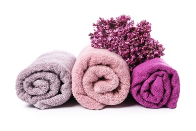 Photo of Soft towels and lilac flowers isolated on white
