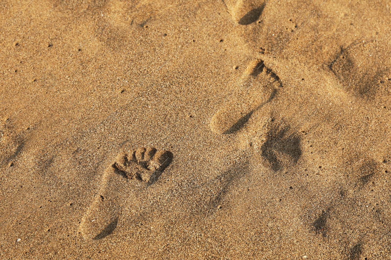 Footprints on sand as background, top view Photo of Footprints on sand as background, top view