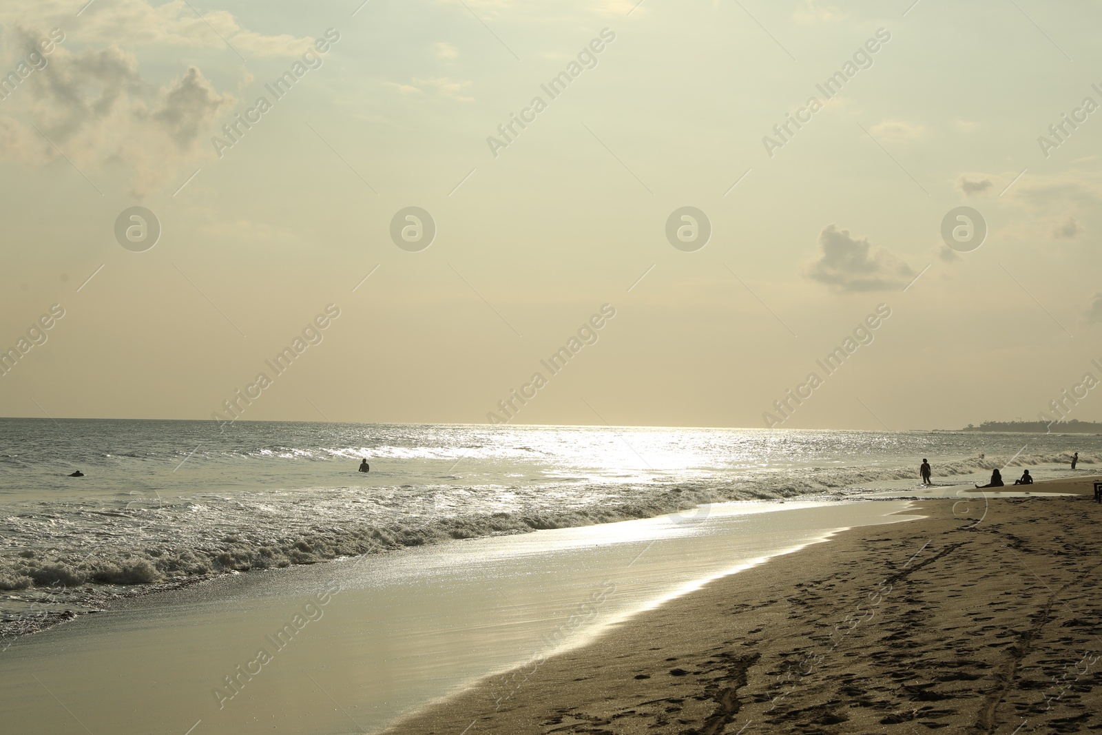 Beautiful view of sea and people relaxing on sandy beach Photo of Beautiful view of sea and people relaxing on sandy beach