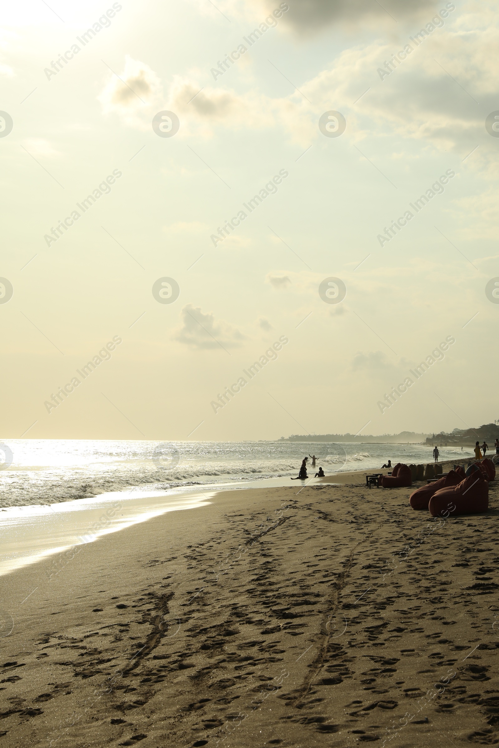 Beautiful view of sea and people relaxing on sandy beach Photo of Beautiful view of sea and people relaxing on sandy beach
