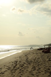 Photo of Beautiful view of sea and people relaxing on sandy beach