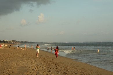 Photo of Bali, Indonesia - May 20, 2025: People spending time on beach by sea
