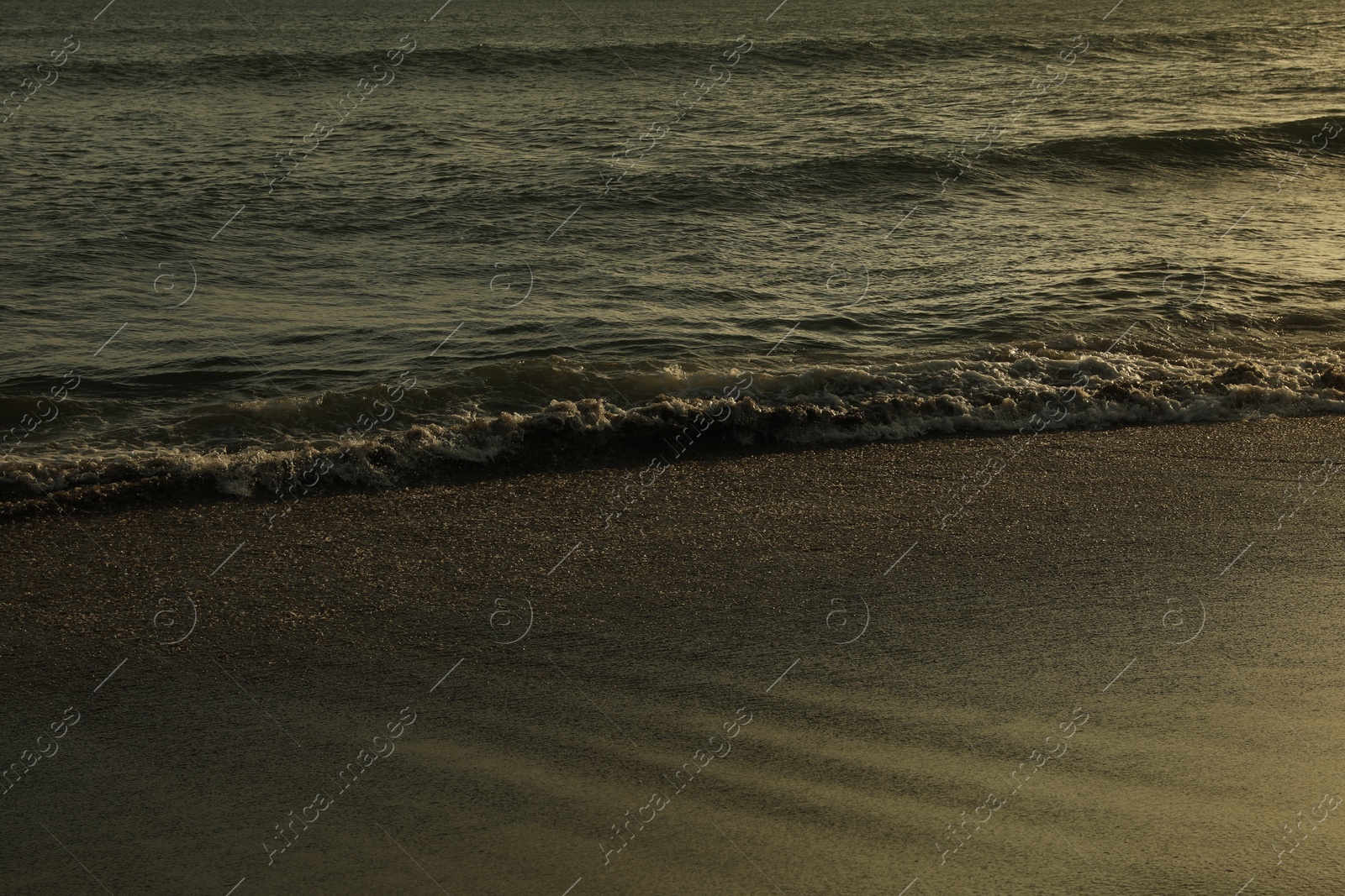 Beautiful wavy sea and wet sandy beach at sunrise Photo of Beautiful wavy sea and wet sandy beach at sunrise