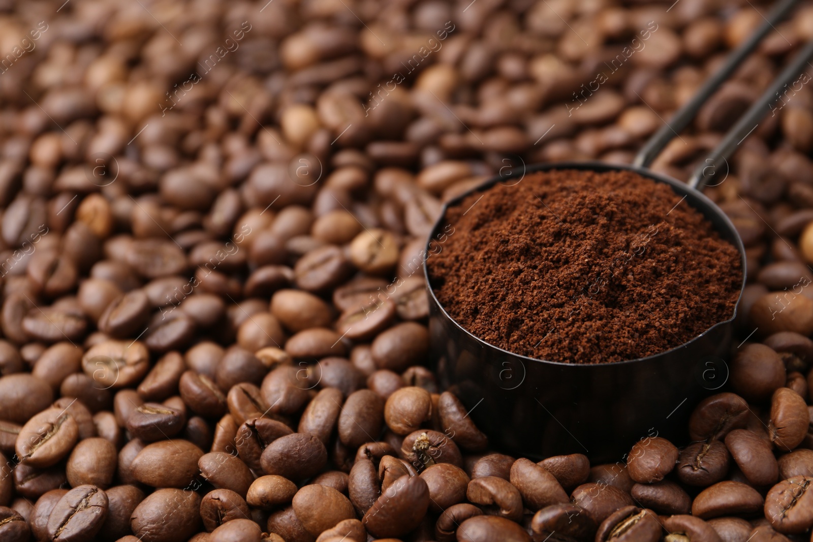 Scoop with instant coffee powder on beans, closeup. Space for text Photo of Scoop with instant coffee powder on beans, closeup. Space for text