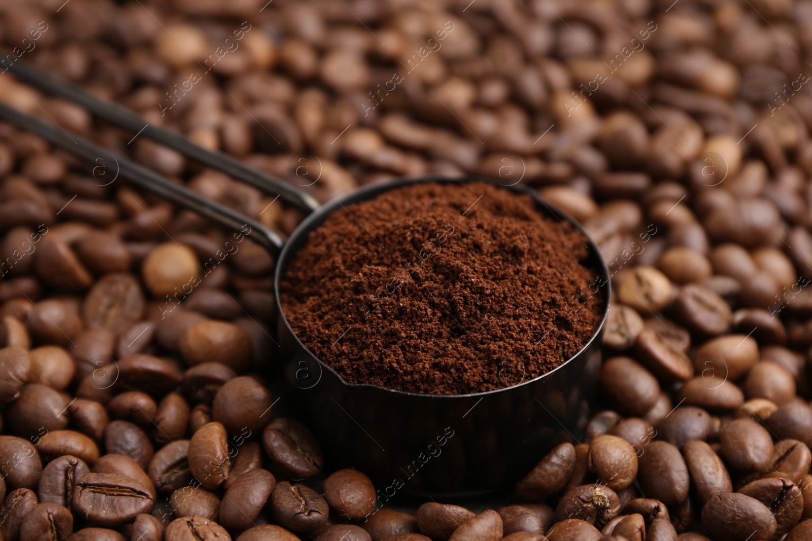 Scoop with instant coffee powder on beans, closeup Photo of Scoop with instant coffee powder on beans, closeup
