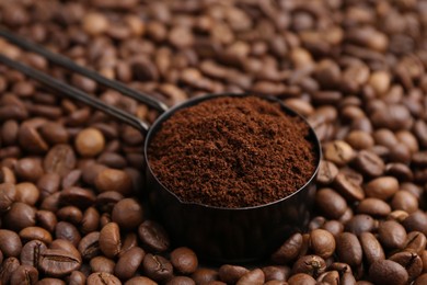 Photo of Scoop with instant coffee powder on beans, closeup