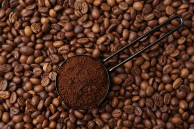 Photo of Scoop with instant coffee powder on beans, top view