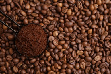 Photo of Scoop with instant coffee powder on beans, top view