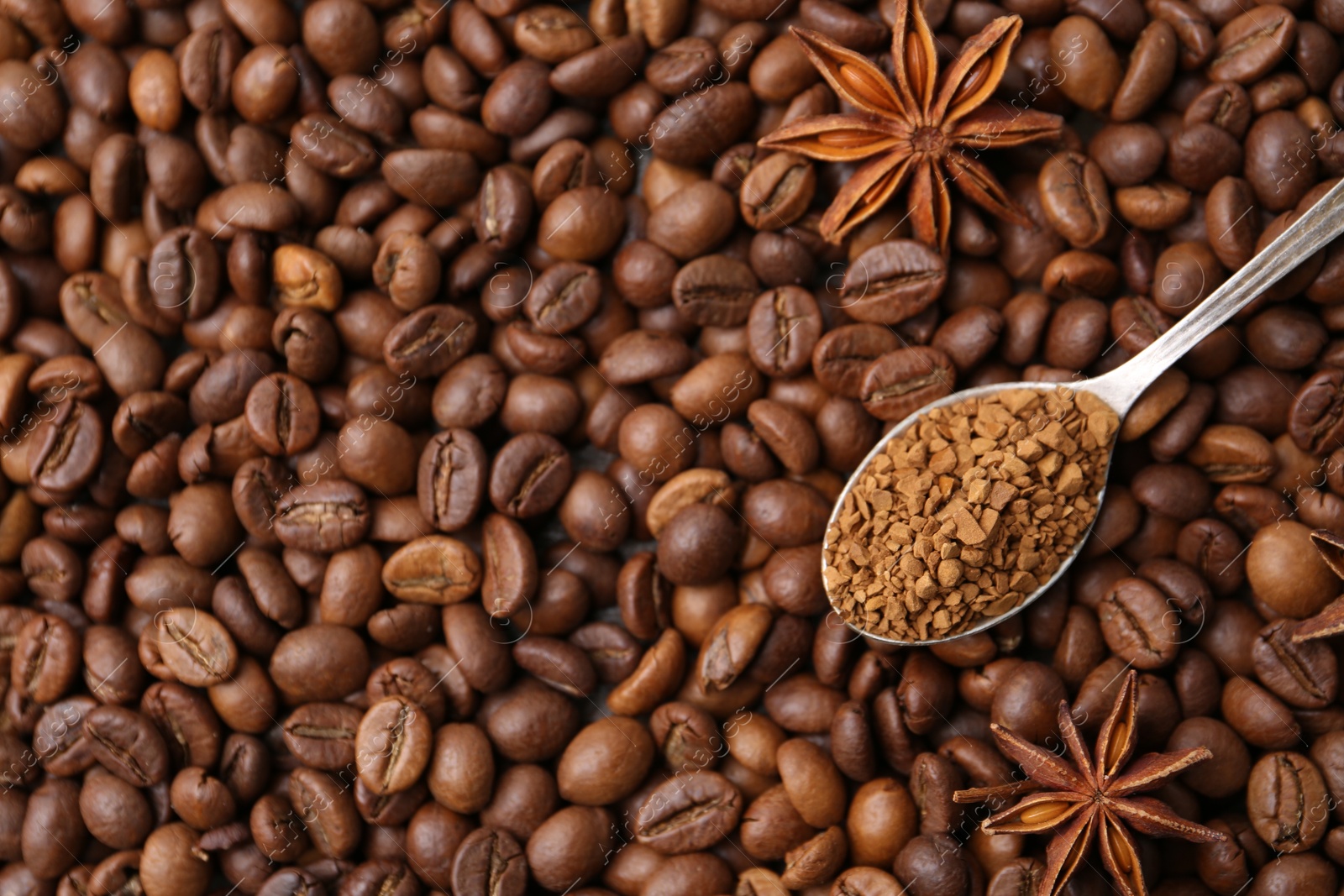 Spoon with granulated instant coffee and star anise on beans, top view. Space for text Photo of Spoon with granulated instant coffee and star anise on beans, top view. Space for text