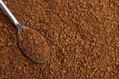 Photo of Spoon on aromatic granulated instant coffee, top view. Space for text