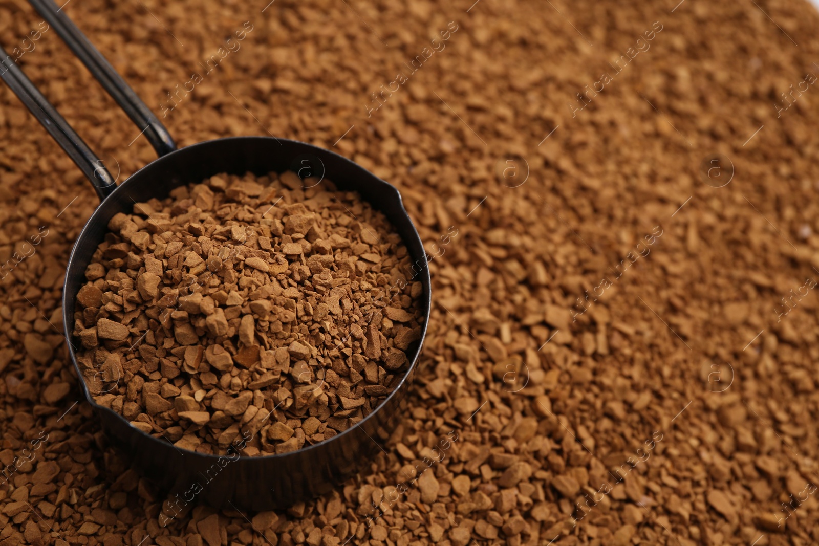 Scoop on aromatic granulated instant coffee, closeup. Space for text Photo of Scoop on aromatic granulated instant coffee, closeup. Space for text