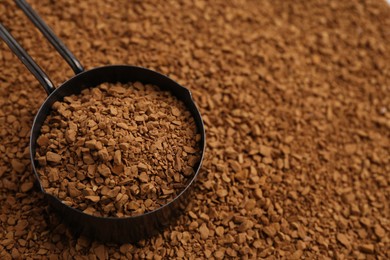 Photo of Scoop on aromatic granulated instant coffee, closeup. Space for text