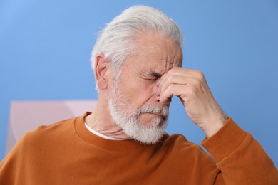 Photo of Senior man suffering from eyestrain at home
