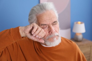 Photo of Senior man suffering from eyestrain at home