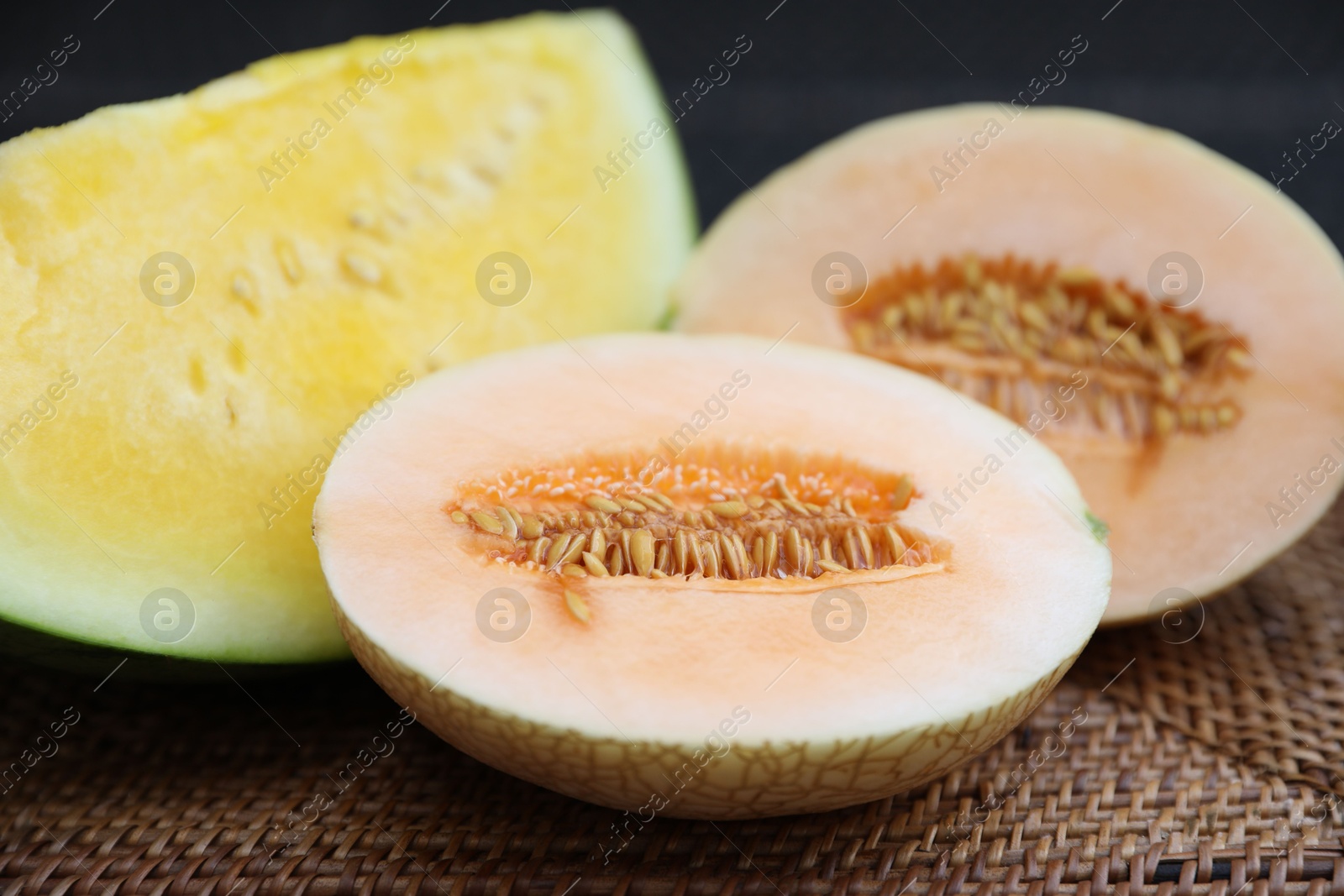 Ripe juicy tropical fruits on wicker table, closeup Photo of Ripe juicy tropical fruits on wicker table, closeup