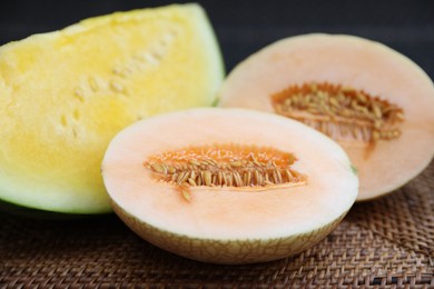 Photo of Ripe juicy tropical fruits on wicker table, closeup