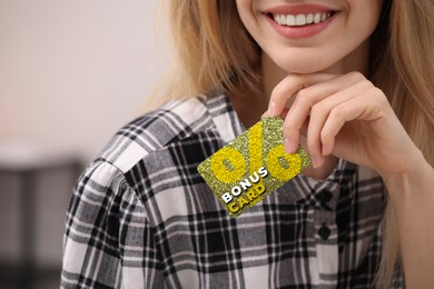 Image of Woman holding Bonus card with stylish design, closeup
