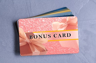 Image of Bonus cards on textured table, top view