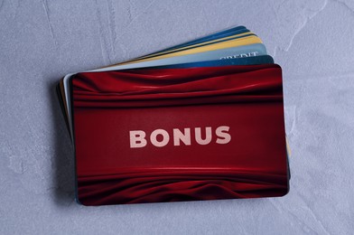 Image of Bonus cards on textured table, top view