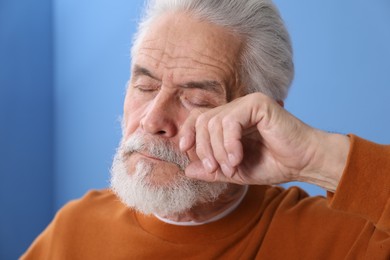 Photo of Senior man suffering from eyestrain at home