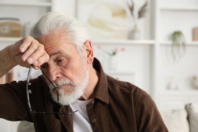Photo of Senior man suffering from eyestrain at home