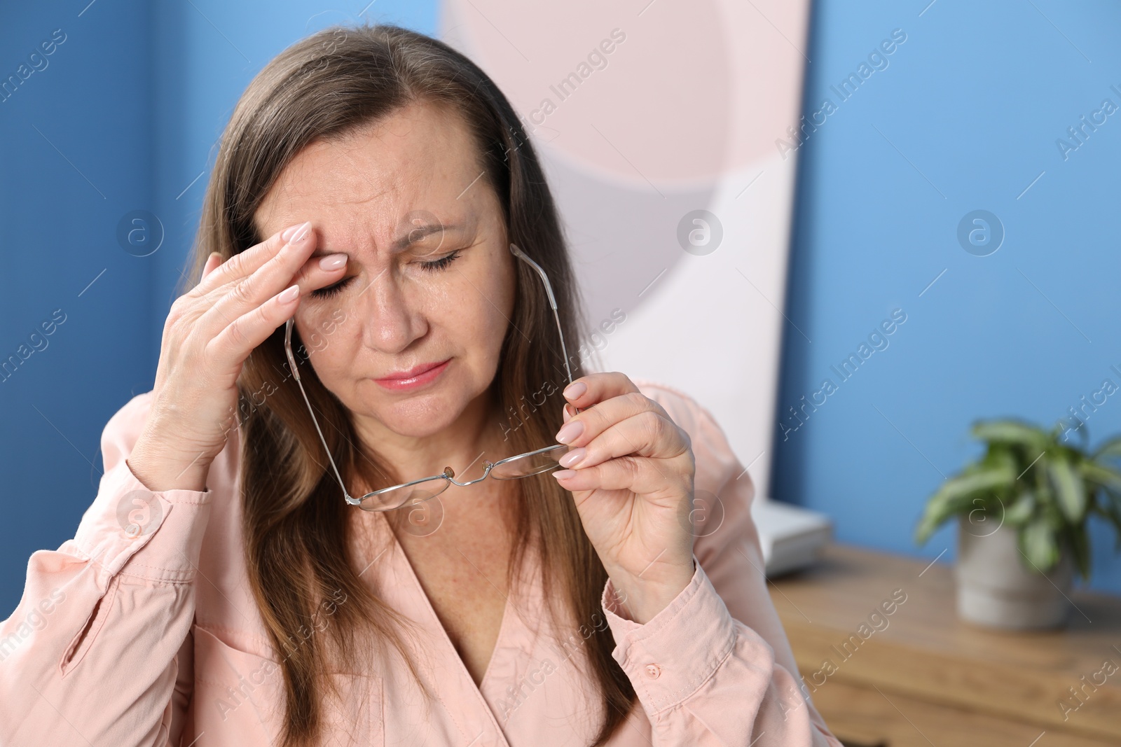 Woman with glasses suffering from eyestrain at home, space for text Photo of Woman with glasses suffering from eyestrain at home, space for text