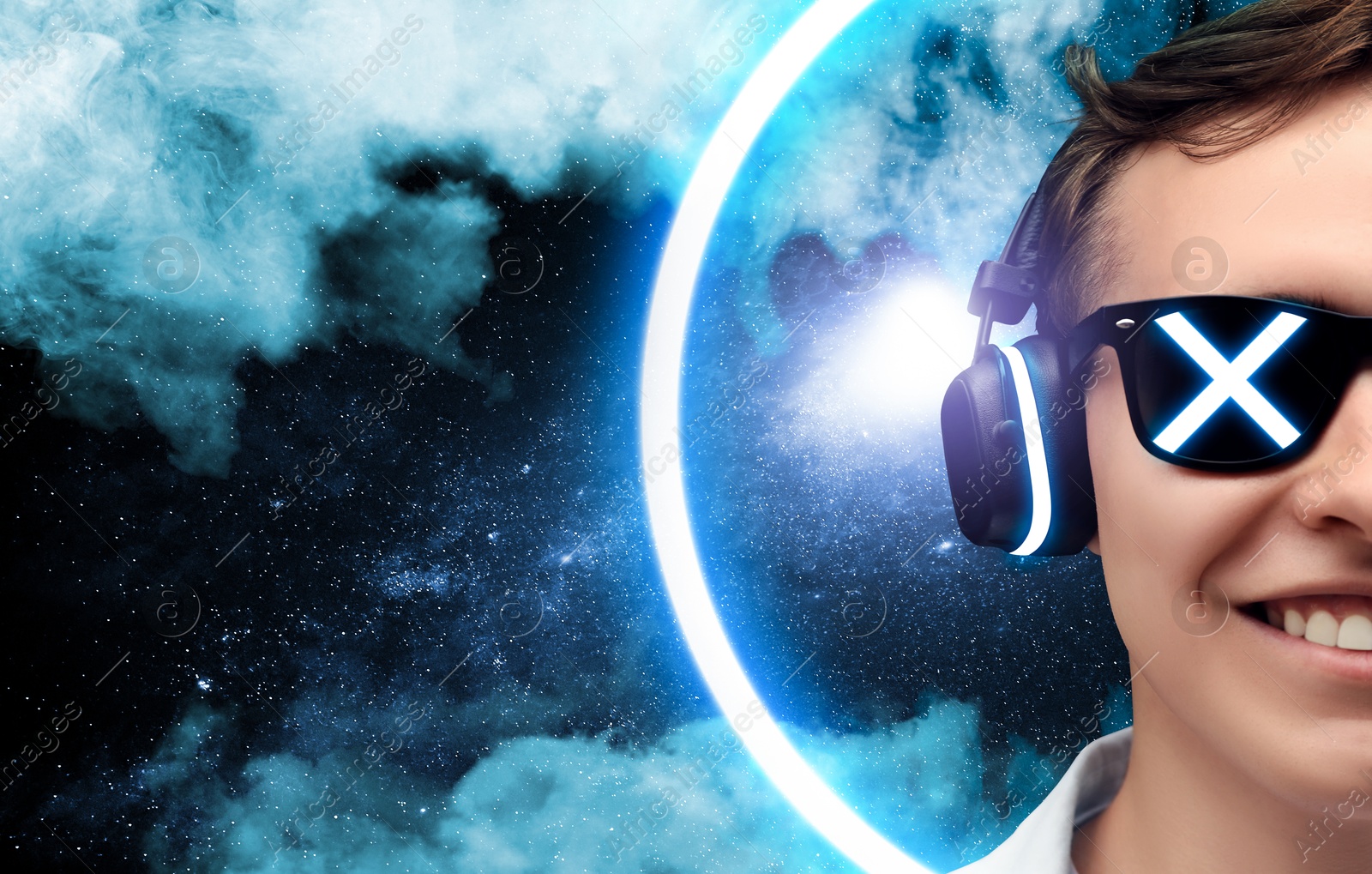 Young man listening to music with headphones against universe Image of Young man listening to music with headphones against universe