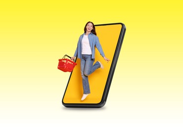 Image of Happy woman with shopping basket jumping out of mobile phone on yellow gradient background. Online ordering