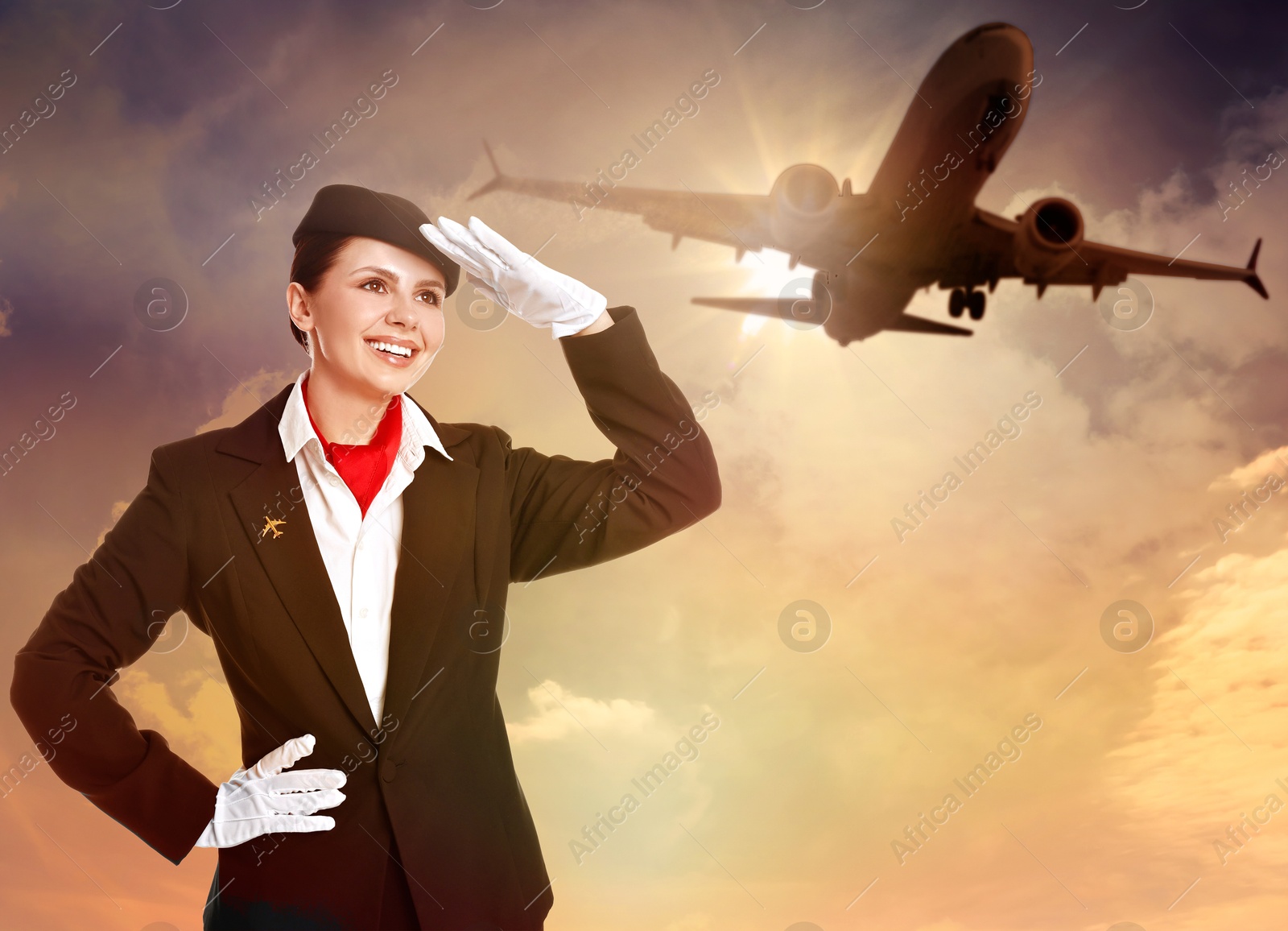 Smiling stewardess against sunset sky with plane and clouds Image of Smiling stewardess against sunset sky with plane and clouds