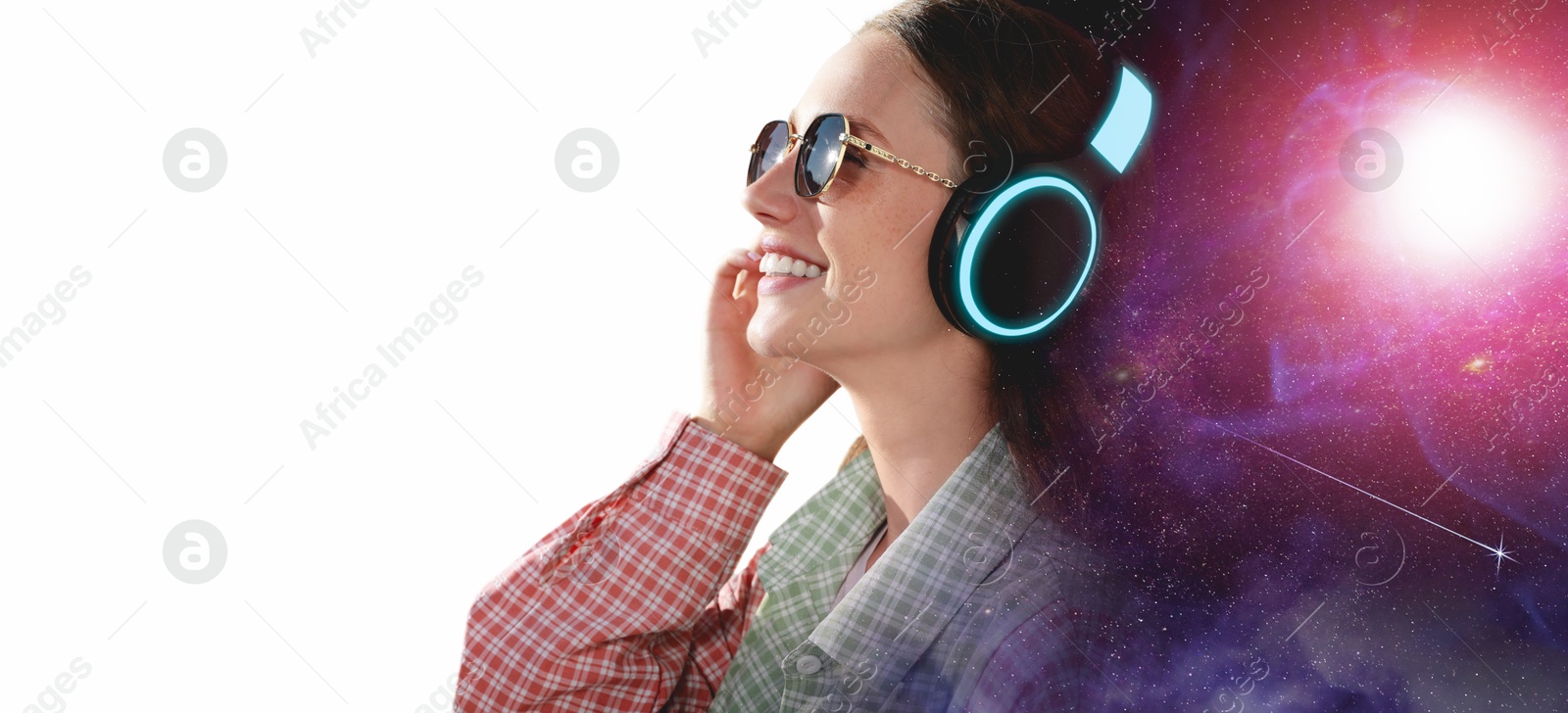Young woman listening to music with headphones on white background, double exposure with universe Image of Young woman listening to music with headphones on white background, double exposure with universe