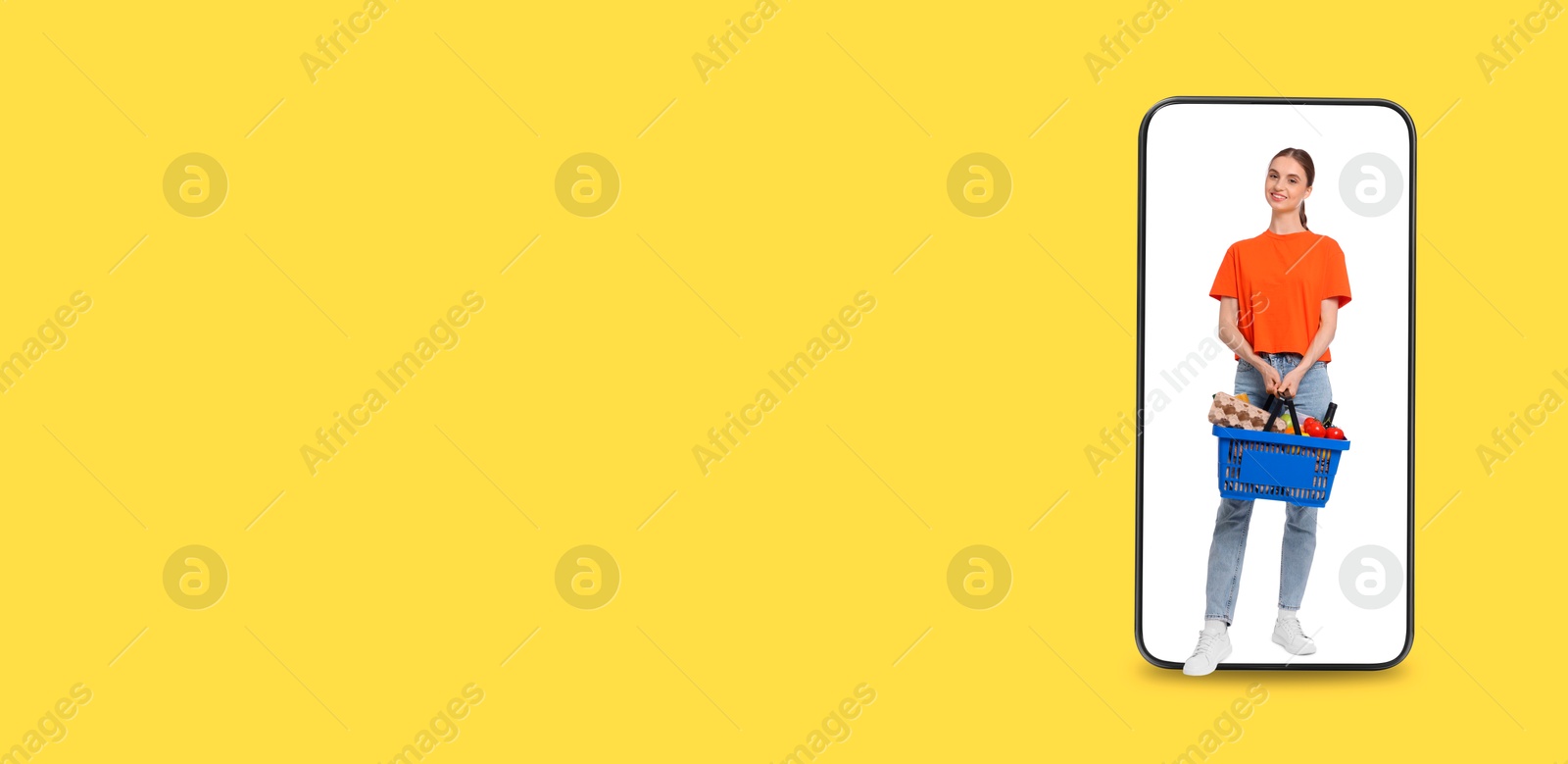 Happy woman with shopping basket walking out of mobile phone on orange background, banner design. Online order Image of Happy woman with shopping basket walking out of mobile phone on orange background, banner design. Online order