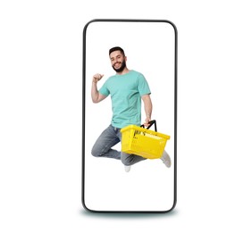 Image of Happy man with shopping basket jumping out of mobile phone on white background. Online ordering