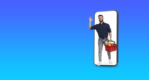Image of Happy man with shopping basket walking out of mobile phone on blue gradient background, banner design. Online order