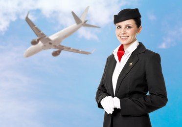 Image of Smiling stewardess against blue sky with plane and clouds