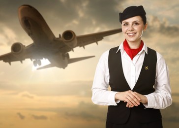 Image of Smiling stewardess against sunset sky with plane and clouds