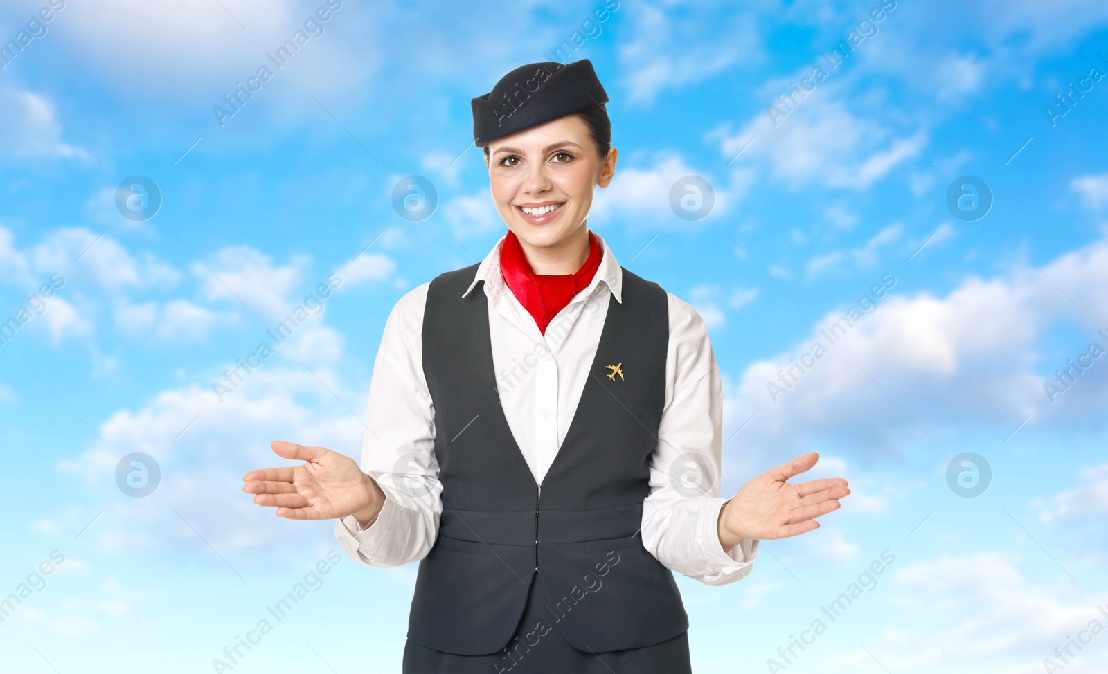 Smiling stewardess against blue sky with clouds Image of Smiling stewardess against blue sky with clouds