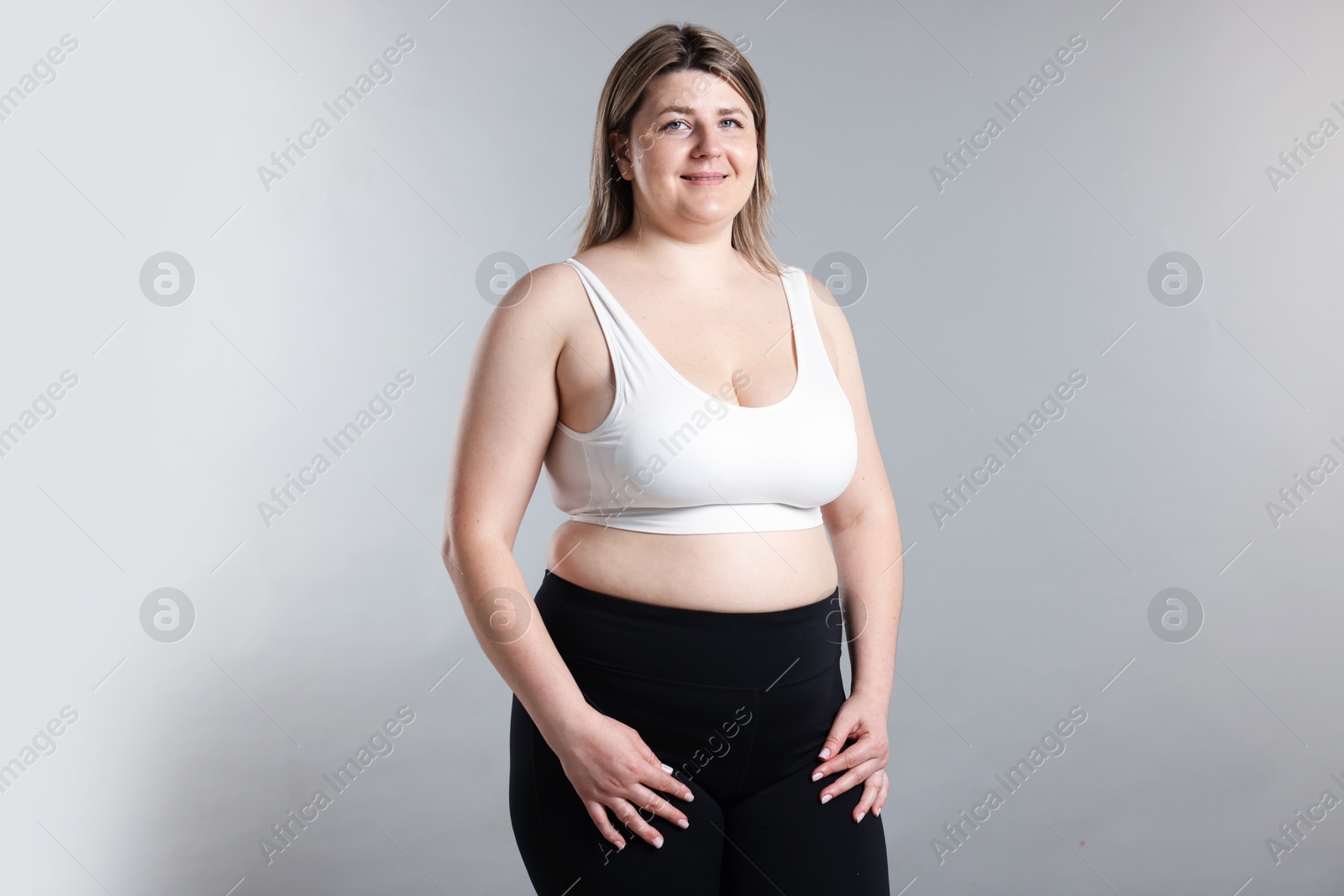 Weight loss. Plus size woman on gray background Photo of Weight loss. Plus size woman on gray background