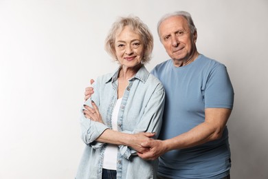 Photo of Portrait of lovely senior couple on white background, space for text