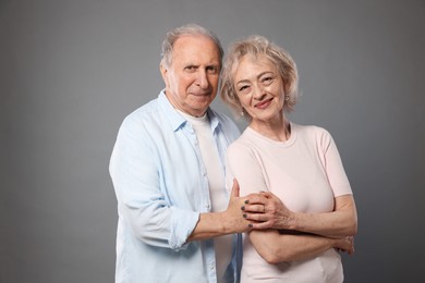 Photo of Portrait of lovely senior couple on grey background